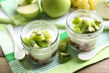 Healthy dessert with muesli and fruits on table