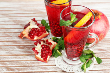 Pomegranate drink in glasses with mint and slices of orange