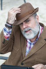 Attractive old man with beard and hat