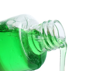 Cosmetic liquid pouring from bottle isolated on white