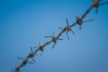 Barbed wire with blue sky