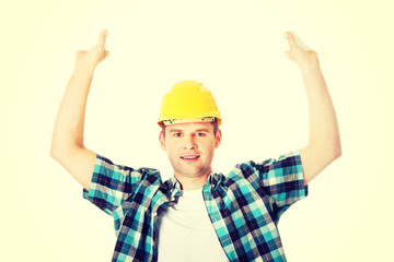 Happy worker presenting empty banner.