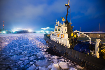 The Icebreaker ship trapped in ice tries to break and leave the  - obrazy, fototapety, plakaty