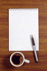 Notepad and coffee cup
