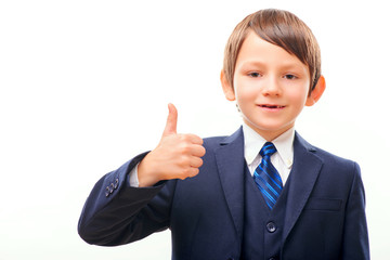 Business child in suit and tie showing his thumb up