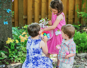 Two Little Girls Looking at Easter Eggs in a Basket