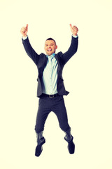 Happy businessman jumping