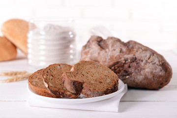 Tasty bread on table on light background