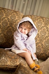 Baby girl in a plush bathrobe