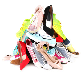 Pile of various female shoes isolated on white