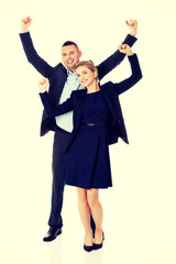 Victorious business couple with hands up