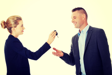 Car salesman handing over the keys