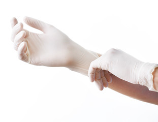 Doctor putting on sterile gloves isolated on white - obrazy, fototapety, plakaty