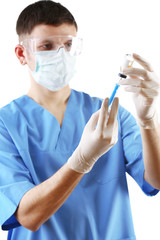 Doctor dialing medicine into syringe from glass bottle isolated