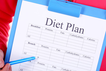 Sports trainer with diet plan close-up