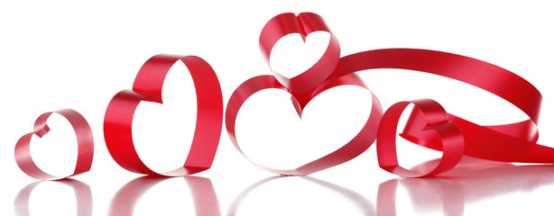 Red ribbons in shape of hearts isolated on white