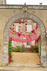 Stone archway with colorful red bunting