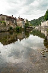 Fototapeta na wymiar Clear Water at the River with Houses at the Sides