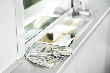 Money on surface near cash department window