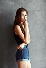 fashion young woman on grunge wall background