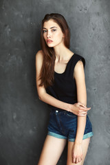 fashion young woman on grunge wall background