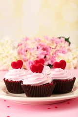 Delicious Valentine Day cupcakes on pink background
