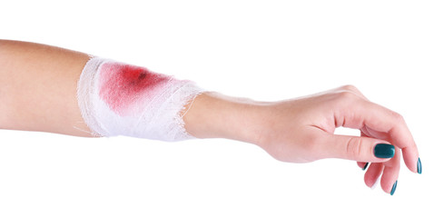 Wounded hand with bandage isolated on white