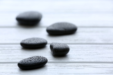Fototapeta na wymiar Spa stones with water drops on wooden background