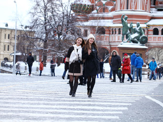 Two girls tourists are photographed in Moscow (Russia)
