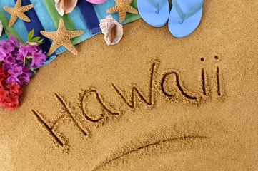 The word Hawaii written in sand on a beach with towel flip flops seashells Hawaiian summer vacation holiday photo © david_franklin