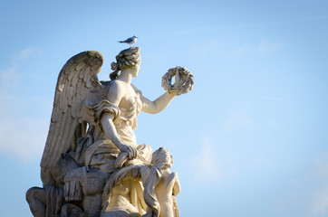 Statue with a bird standing on top