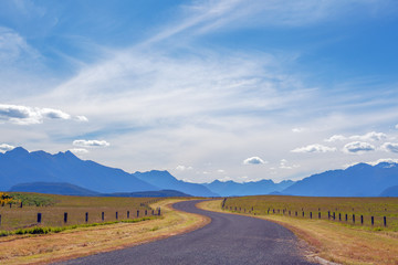 Pastoral winding country road and mountains in Fiordland, New Ze
