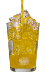 Pouring orange drink into glass full of ice