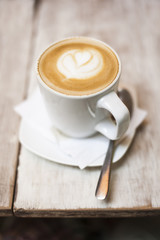 cup of Cappuccino on a wooden table