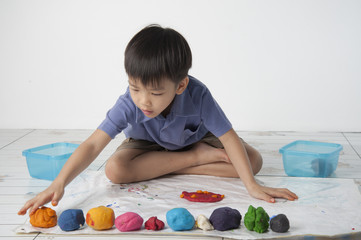 Fototapeta premium Boy play dough