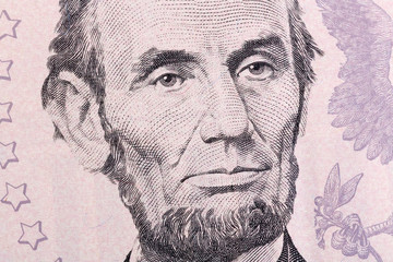 Macro portrait of Abraham Lincoln on five U.S. dollar bill.