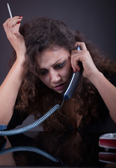 Young crying woman in depression  calling on phone