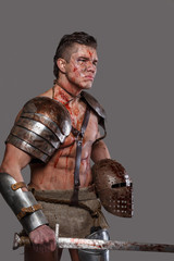 Wounded gladiator with muscular body in armour