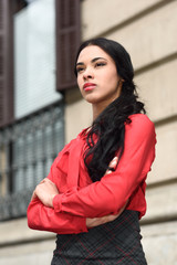 Fototapeta premium Hispanic stewardess in urban background