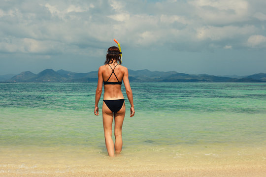 Woman with snorkel on the beach