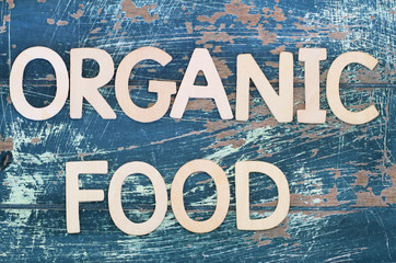 Organic food written with wooden letters on rustic wood