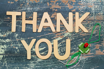 Thank you written with wooden letters and four-leaf clover