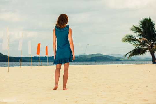 Woman on tropical beach with flags
