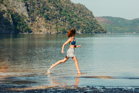 Woman running on tropical beach