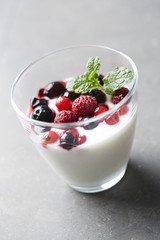Jar of fresh yoghurt with summer fruits,  studio