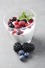 Jar of fresh yoghurt with summer fruits,  studio