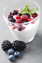 Jar of fresh yoghurt with summer fruits,  studio