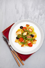 fresh vegetable salad with mozzarella on grey