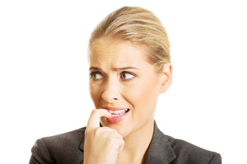 Stressed young woman biting her nails