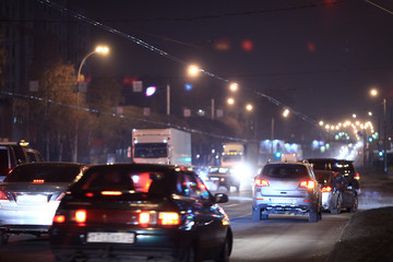 Night road in the city of lights cars traffic jams